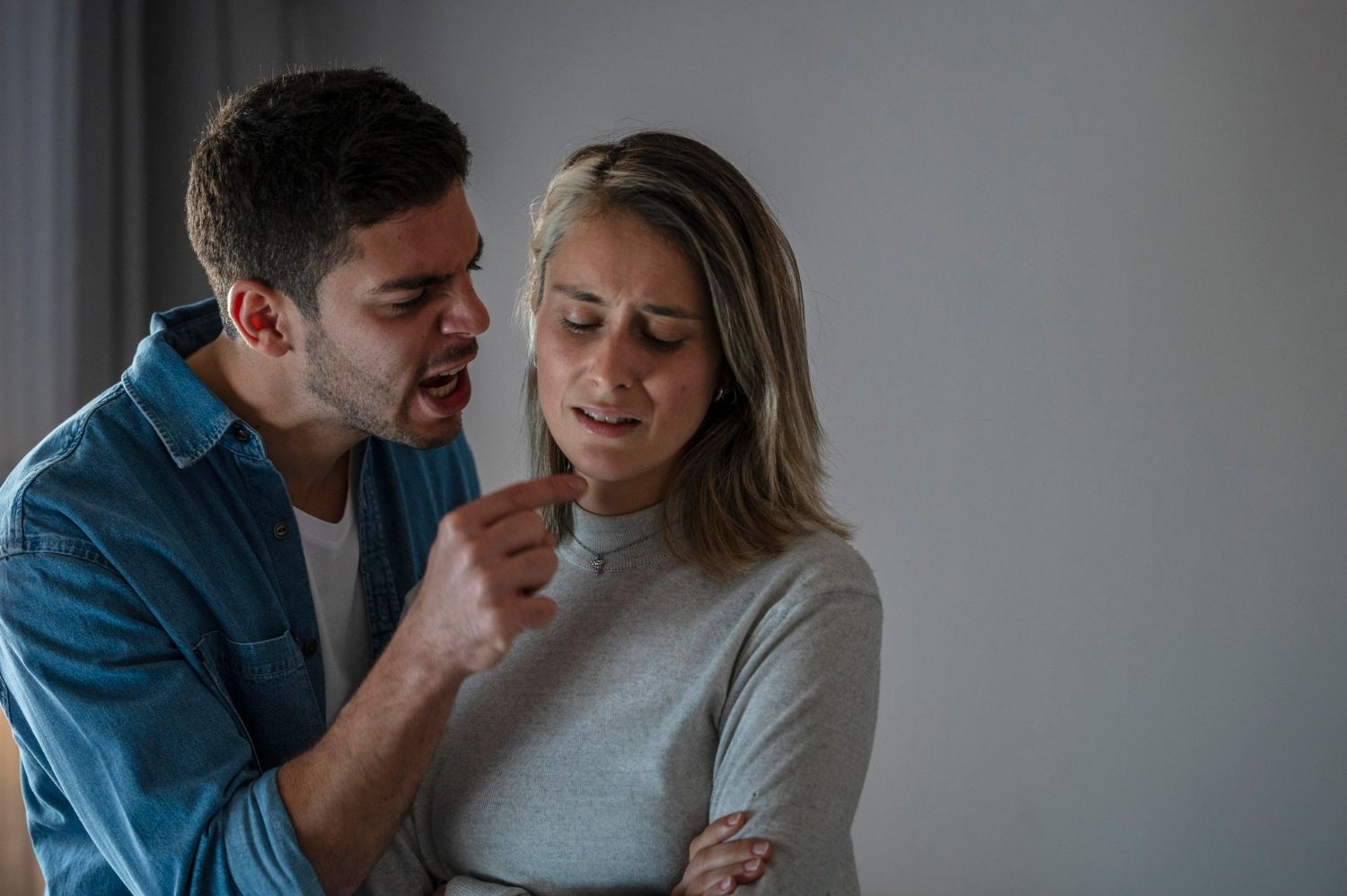 A man shouts and points at a woman