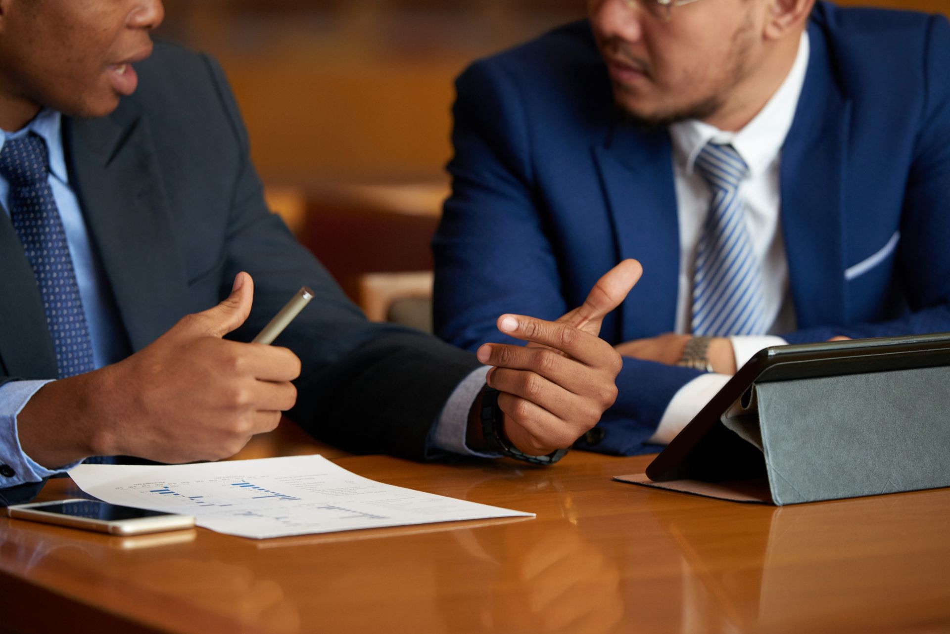what-is-a-waiver-of-arraignment-in-texas Two professionals in suits discuss at a table