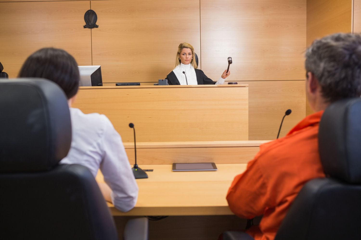 A judge in a black robe presides over a courtroom