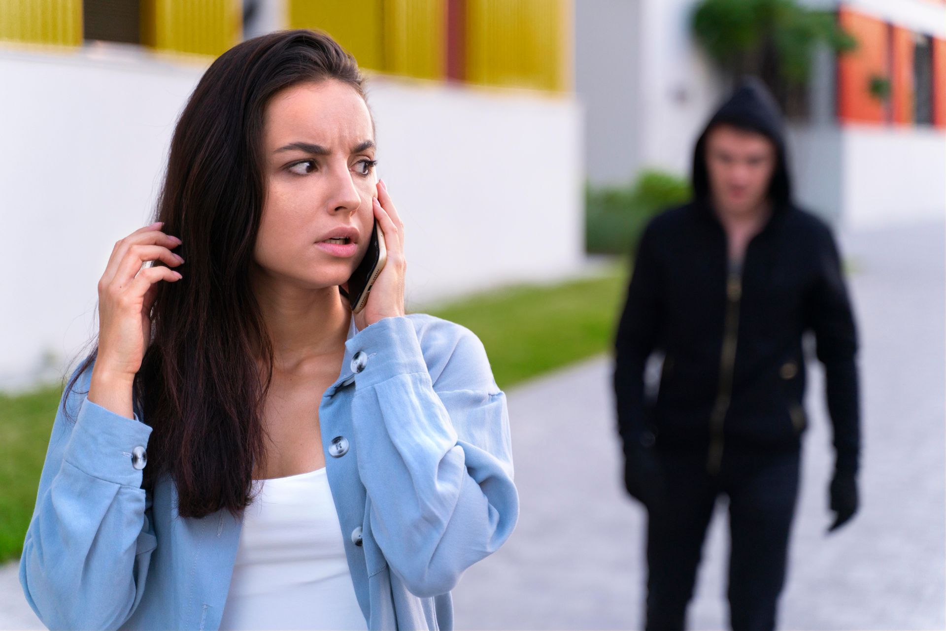 A worried woman talks on her phone