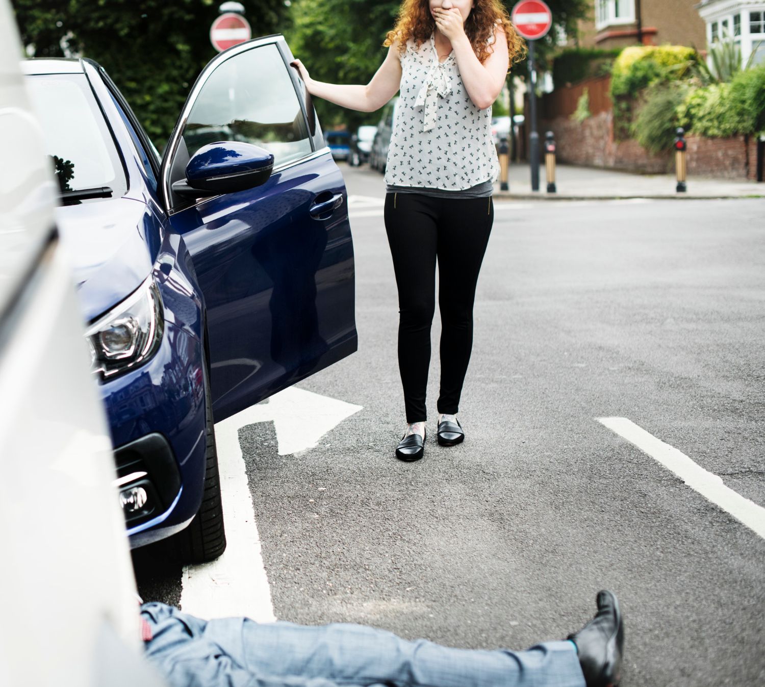 A shocked woman stands by an open car door