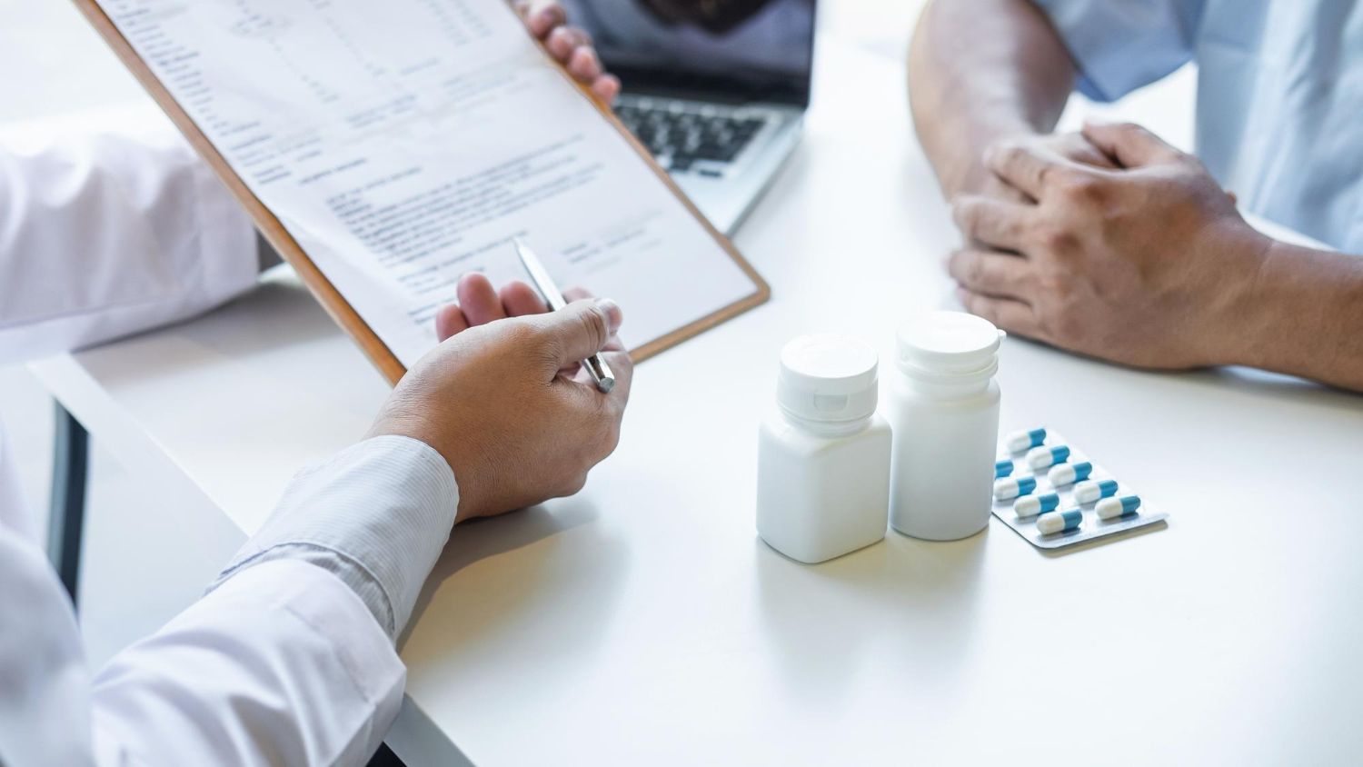 A doctor reviews medical documents with a patient